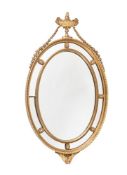 A GILTWOOD AND COMPOSITION WALL MIRROR IN GEORGE III STYLE