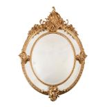 A VICTORIAN GILTWOOD AND COMPOSITION OVAL WALL MIRROR