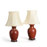 A PAIR OF RED AND GILT TABLE LAMPS