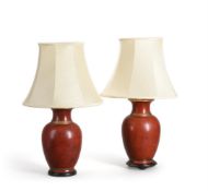 A PAIR OF RED AND GILT TABLE LAMPS