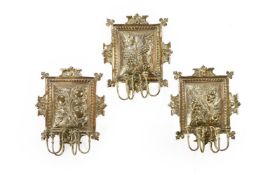 A SET OF THREE BRASS WALL SCONCES IN ARTS AND CRAFTS TASTE