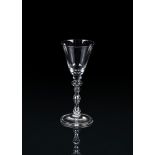 A LIGHT BALUSTER WINE GLASS OF NEWCASTLE TYPE