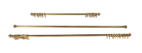 A SUITE OF THREE BRASS CURTAIN POLES