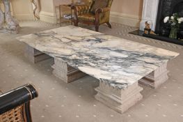 A LARGE VARIEGATED MARBLE LOW CENTRE TABLE