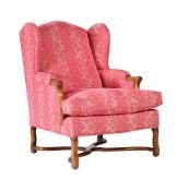 A CARVED BEECH AND UPHOLSTERED WING ARMCHAIR IN WILLIAM AND MARY STYLE