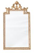 A CONTINENTAL GILTWOOD AND COMPOSITION WALL MIRROR IN EARLY 19TH CENTURY TASTE