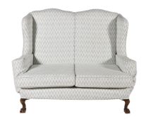 A WING-BACK TWO SEATER SOFA IN GEORGE III STYLE