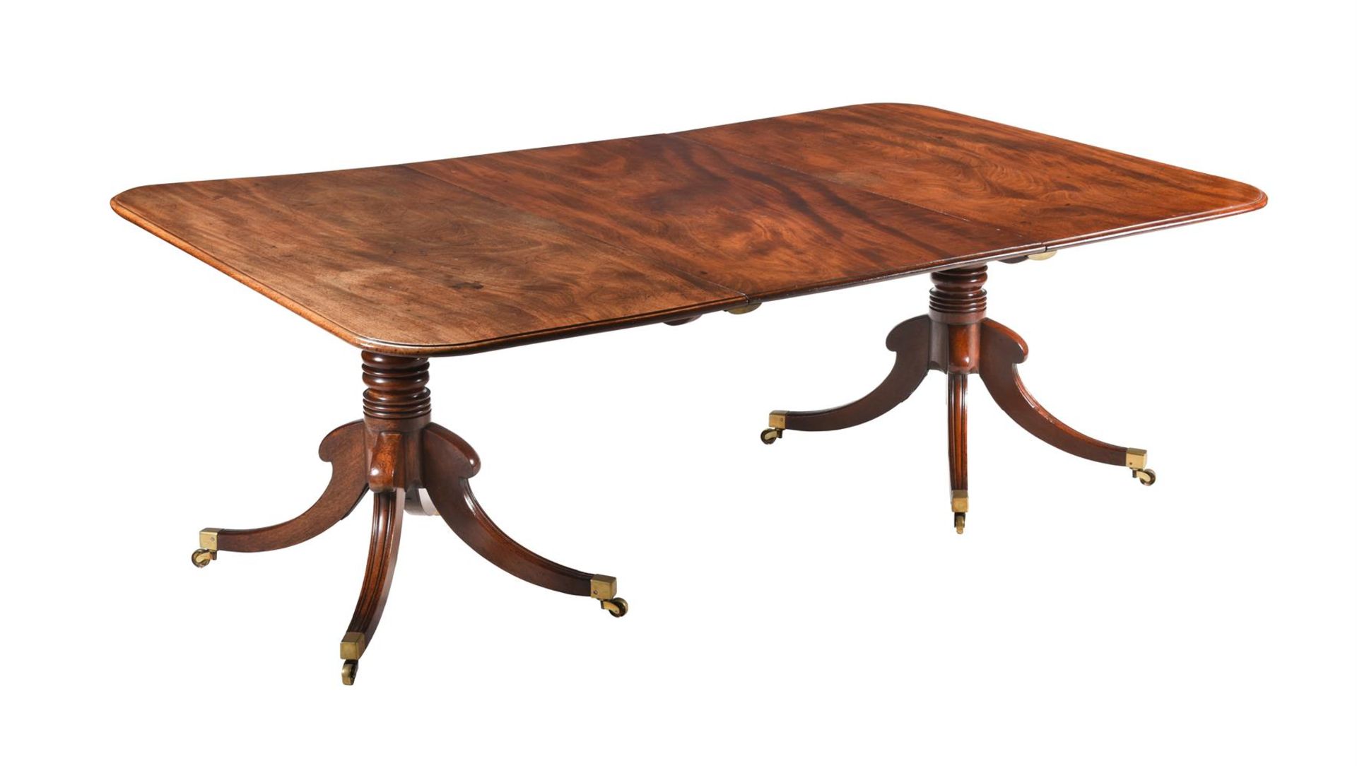 A REGENCY MAHOGANY TWIN PEDESTAL DINING TABLE