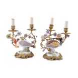 A PAIR OF CONTINENTAL PORCELAIN AND GILT METAL MOUNTED AND FLOWER ENCRUSTED TWIN-BRANCH TABLE LAMPS