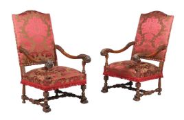 A PAIR OF FRENCH CARVED WALNUT AND UPHOLSTERED OPEN ARMCHAIRS IN LOUIS XIV STYLE