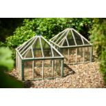 A PAIR OF PAINTED AND GLAZED GARDEN CLOCHES