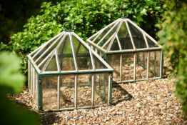 A PAIR OF PAINTED AND GLAZED GARDEN CLOCHES
