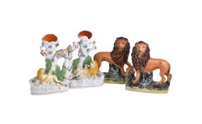 A PAIR OF STAFFORDSHIRE MODELS OF LIONS
