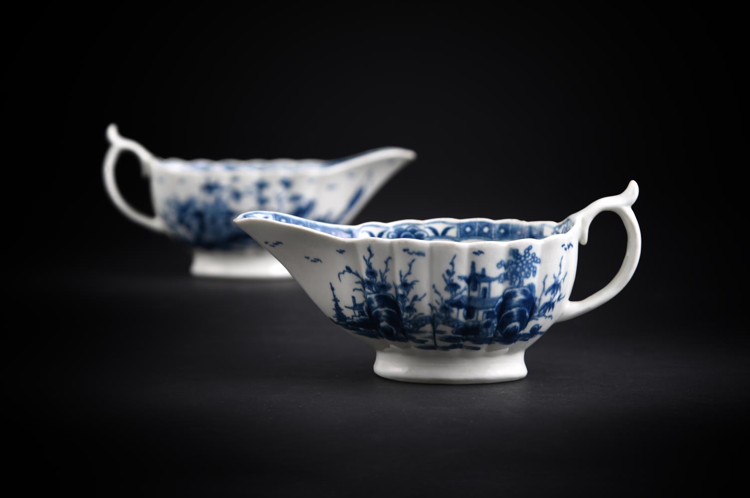 A PAIR OF WORCESTER BLUE AND WHITE SAUCEBOATS PAINTED WITH THE SO-CALLED 'MISSION CHURCH' PATTERN