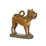 AN INDIAN CARVED AND POLYCHROME MODEL OF A TIGER