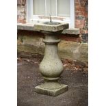 A WATERLOO BRIDGE GRANITE BALUSTER AND BRASS SUNDIAL