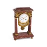 A FRENCH RED MARBLE MANTEL CLOCK