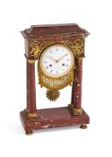 A FRENCH RED MARBLE MANTEL CLOCK