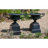 A PAIR OF VICTORIAN CAST IRON TWIN HANDLED PLANTERS ON STANDS