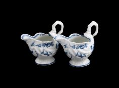 A PAIR OF WORCESTER BLUE AND WHITE DOLPHIN EWERS