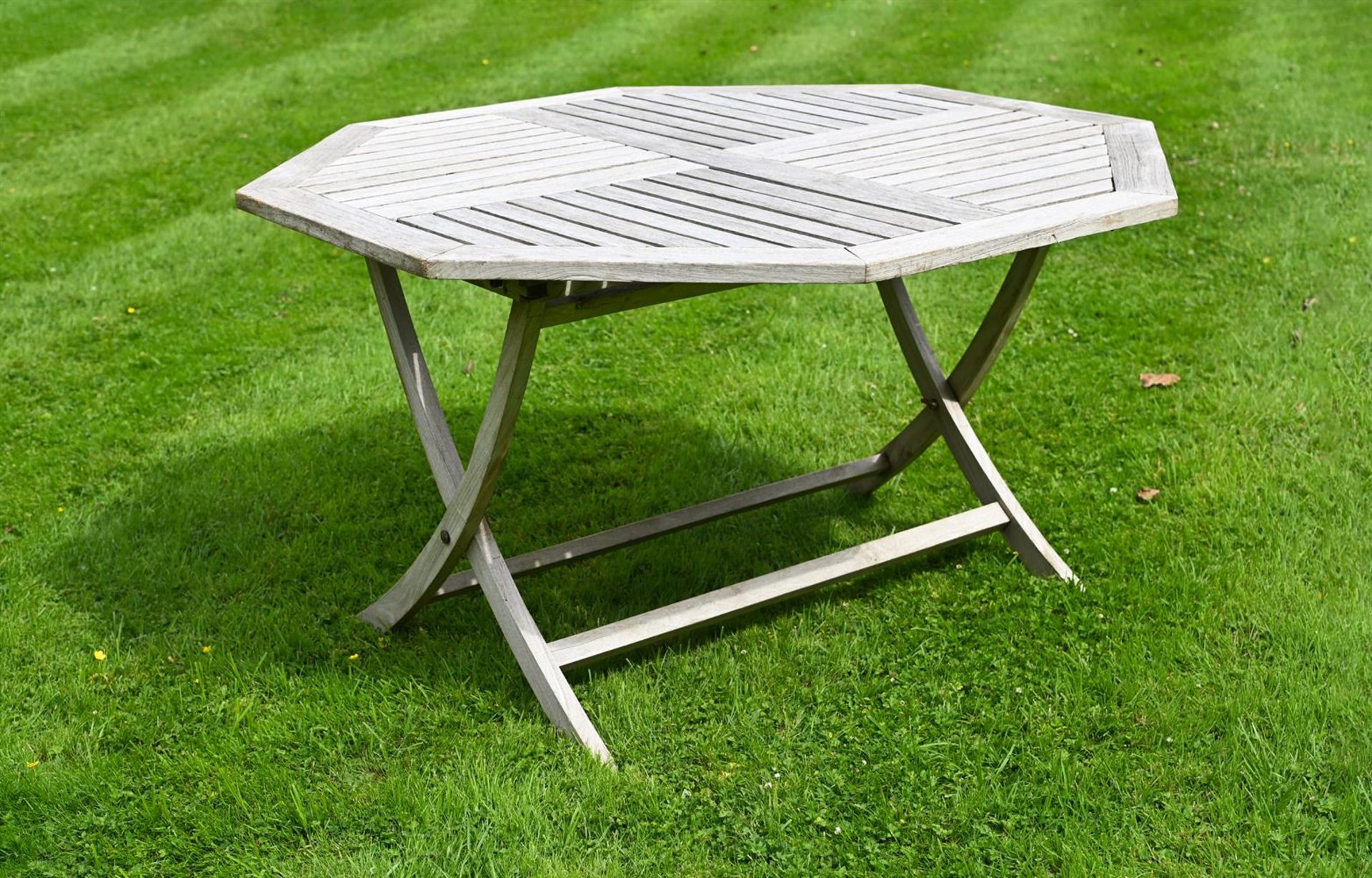 AN OCTAGONAL TEAK GARDEN TABLE