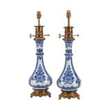 A PAIR OF BLUE AND WHITE PORCELAIN AND GILT METAL MOUNTED TABLE LAMPS