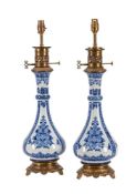 A PAIR OF BLUE AND WHITE PORCELAIN AND GILT METAL MOUNTED TABLE LAMPS