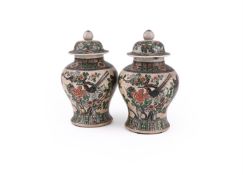 A PAIR OF CHINESE CRACKLED GLAZED FAMILLE ROSE JARS AND COVERS
