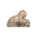 A CARVED ALABASTER MODEL OF A RECUMBENT LION