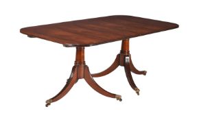 A MAHOGANY TWIN PEDESTAL DINING TABLE IN GEORGE III STYLE