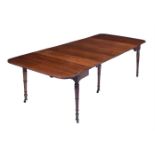 A GEORGE IV MAHOGANY CONCERTINA ACTION DINING TABLE