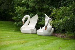 A COMPANION PAIR OF FIBREGLASS GARDEN SEATS IN THE FORM OF SWANS