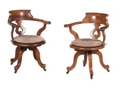 A MATCHED PAIR OF VICTORIAN WALNUT AND OAK DESK CHAIRS