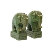 A PAIR OF GREEN STAINED ALABASTER MODELS OF BOOKENDS