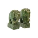 A PAIR OF GREEN STAINED ALABASTER MODELS OF BOOKENDS