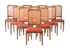 A SET OF TEN WALNUT AND CANEWORK DINING CHAIRS