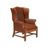 AN OAK AND LEATHER UPHOLSTERED WING BACK ARMCHAIR