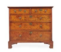 A FIGURED WALNUT, WALNUT AND LINE INLAID CHEST OF DRAWERS