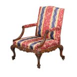 A CARVED MAHOGANY OPEN ARMCHAIR, IN GEORGE II STYLE