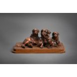 A SWISS CARVED PINE FIGURE GROUP OF A BERNESE MOUNTAIN DOG OR ST BERNARD AND THREE PUPS