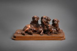 A SWISS CARVED PINE FIGURE GROUP OF A BERNESE MOUNTAIN DOG OR ST BERNARD AND THREE PUPS