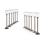 A SET OF TWELVE METAL CANDLESTICKS WITH GLASS SHADES, BY ANOUSKA HEMPEL