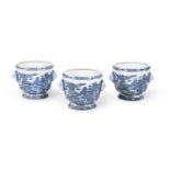 A SET OF THREE CHINESE BLUE AND WHITE JARDINIÈRES WITH LION MASKS