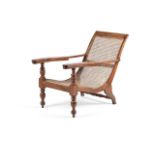 A TEAK AND CANED PLANTATION CHAIR20TH CENTURYwith hinged extending arms