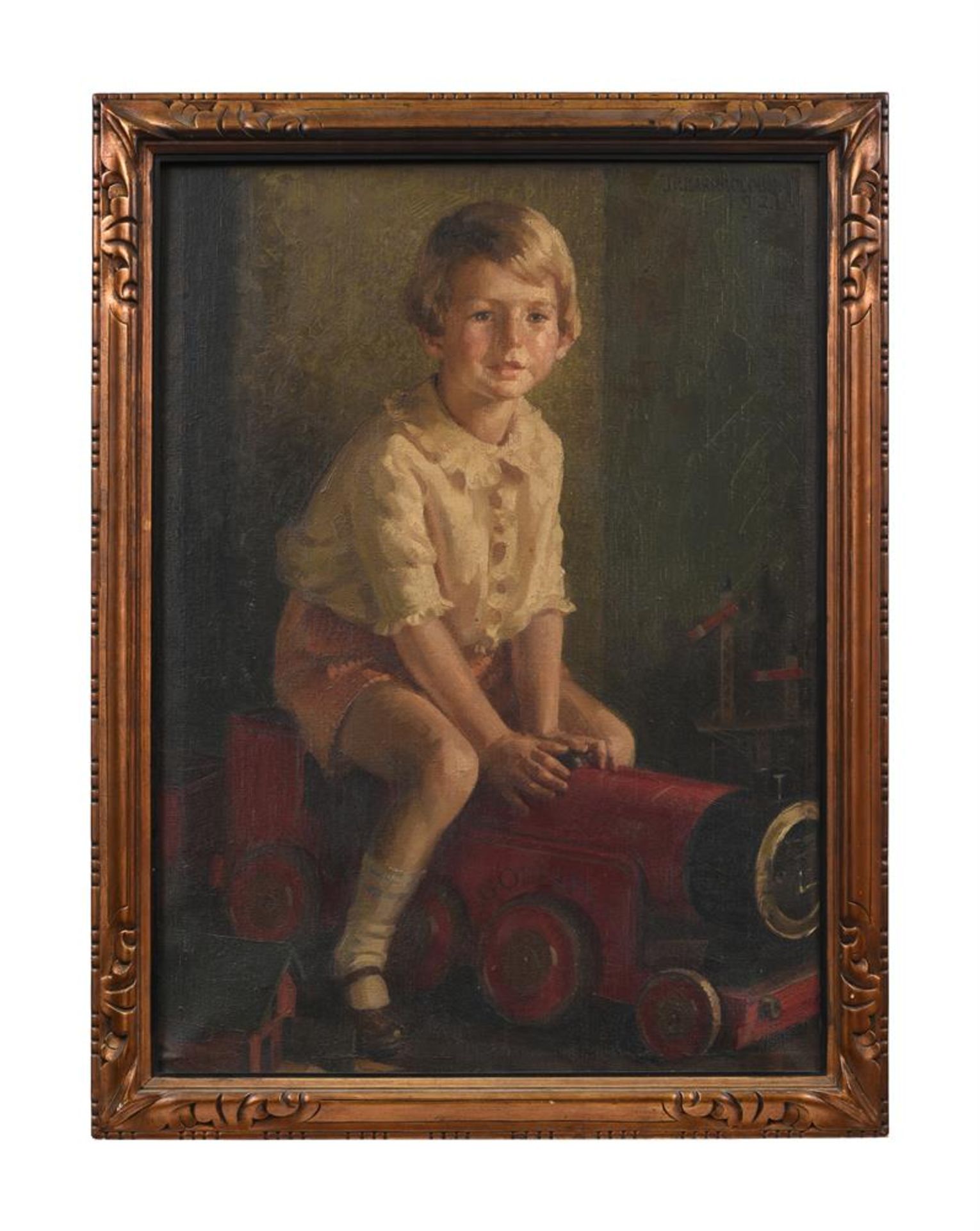 JAMES P. BARRACLOUGH (BRITISH 1891-1942), PORTRAIT OF A YOUNG BOY WITH A TOY TRAIN