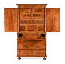 A WILLIAM AND MARY FIGURED WALNUT SECRETAIRE CABINET ON CHEST, CIRCA 1690