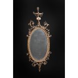 A GEORGE III CARVED GILTWOOD WALL MIRROR, AFTER DESIGNS BY ROBERT ADAM, CIRCA 1770