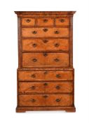 A GEORGE II WALNUT AND FEATHER-BANDED SECRETAIRE CHEST ON CHEST, CIRCA 1735