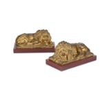 A PAIR OF GILT METAL FIGURES OF RECUMBENT LIONS, 19TH CENTURY