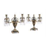 A PAIR OF REGENCY PATINATED AND GILT BRONZE TWIN LIGHT CANDELABRA, EARLY 19TH CENTURY